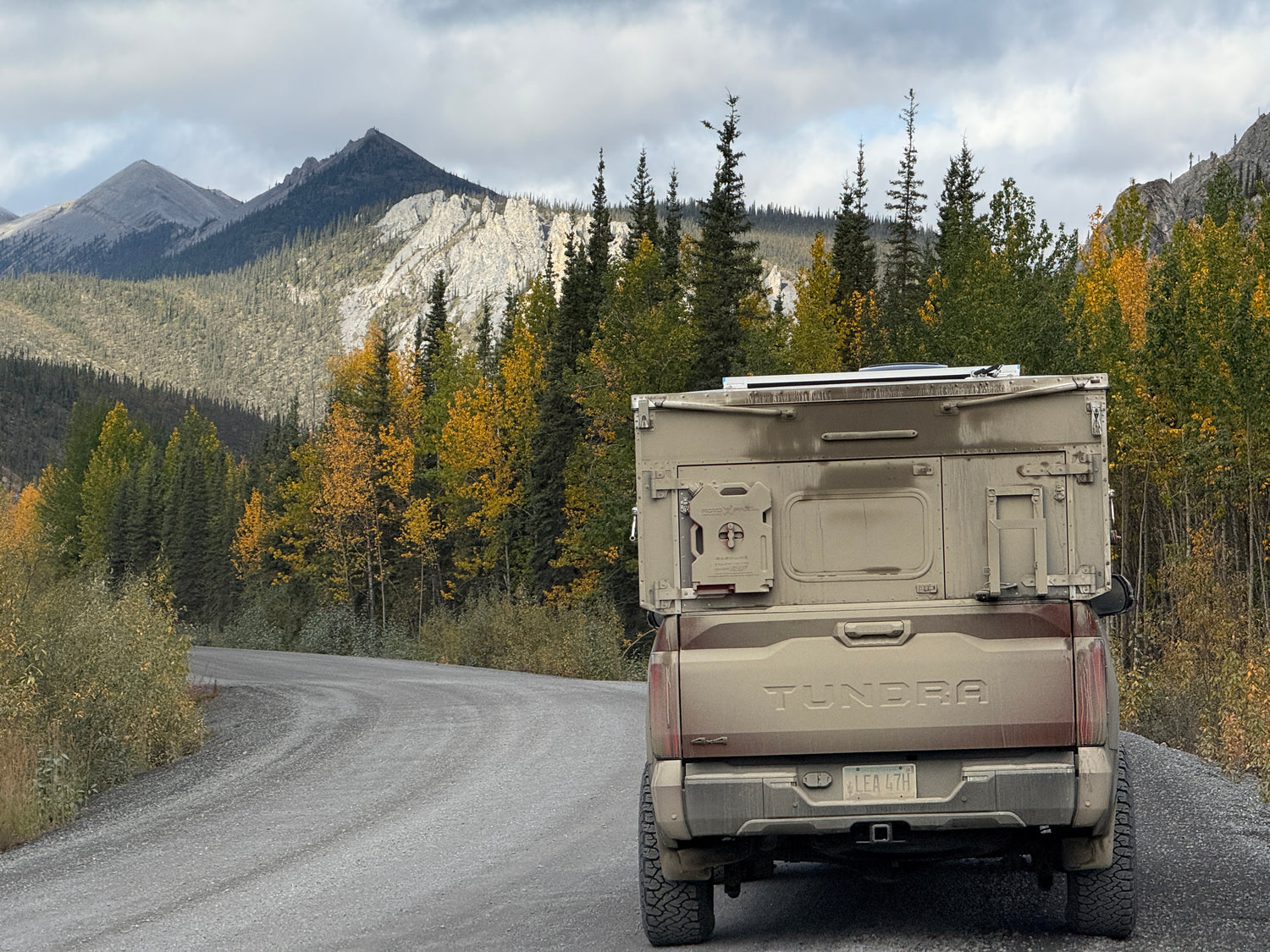Toyota Tundra truck on a mountain road with trees and mountains in the background