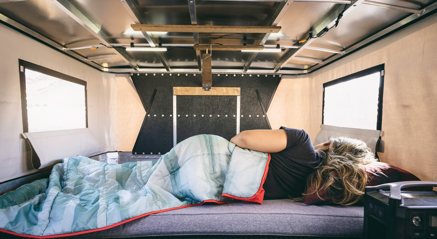 Person Sleeping on OVRLND Pop Up Camper Bed